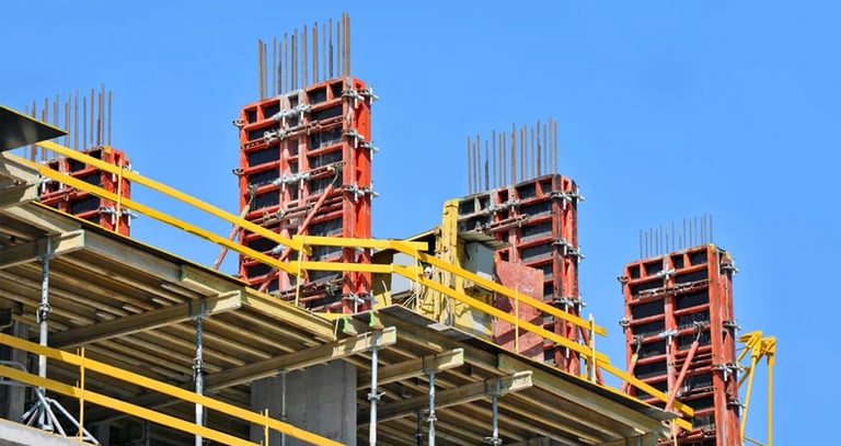 a building with a lot of construction materials and a blue sky