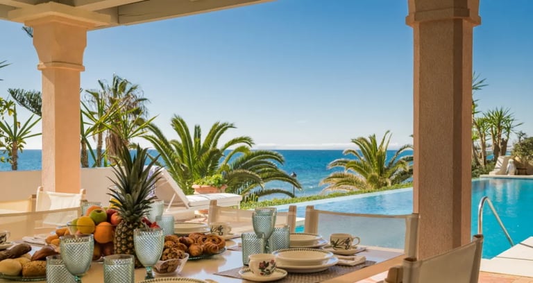 Poolside dining area at Villa El Rincon with sea views