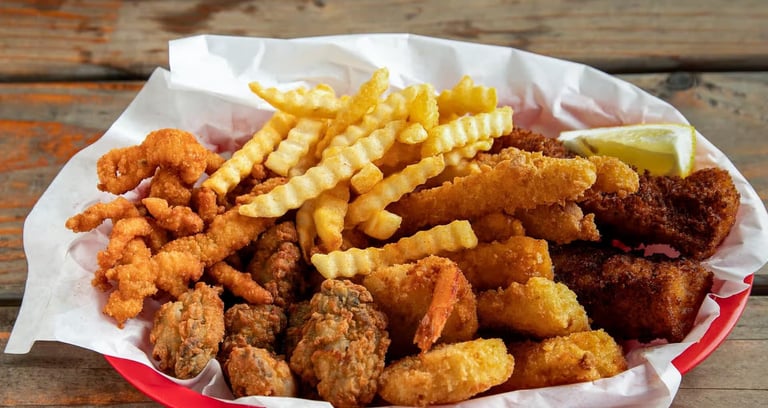 Captain’s Combo Platter Meal with fried fish, clams, oysters, shrimp, calamari, and crinkle‑cut fries from Captain’s Galley