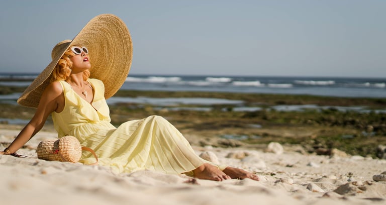 Portrait of woman sitting on sand during beach photoshoot at Melasti Beach Bali