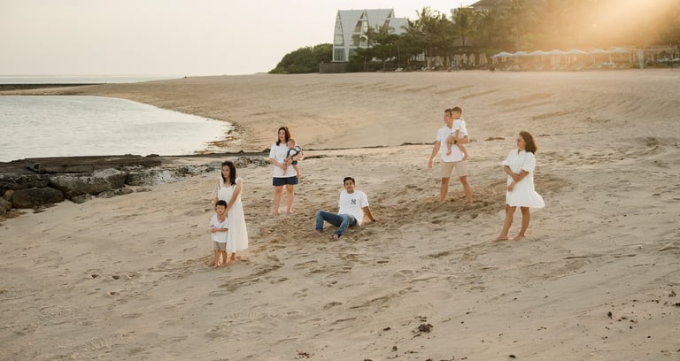 Children playing on the beach during a relaxed family photography session at The Apurva Kempinski Nusa Dua Bali