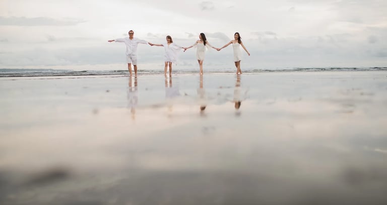 Janice family reflected on the shoreline during a sunset session at Indigo Seminyak Bali