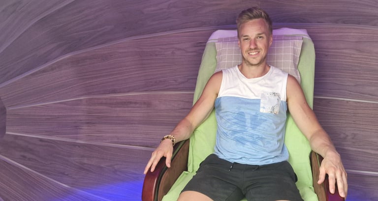 A man relaxing inside the Harmonic Egg for bio-energy and sound frequency therapy.