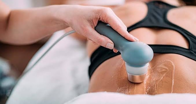 UST, TENS machine applied on lower back for pain management.