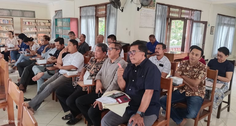 a group of DPP DKP Paroki Tuka sitting in chairs in a room