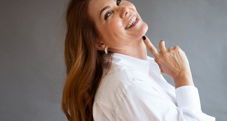 a woman with long hair and a white shirt