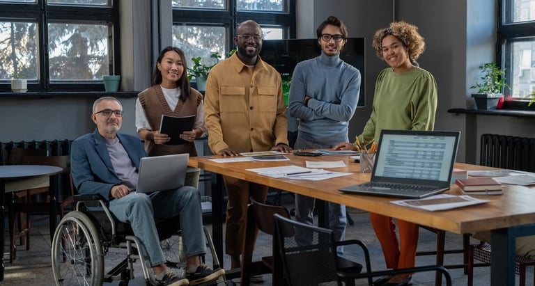 Employees gather around a work table