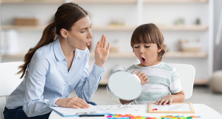 a woman sitting at a table with a child