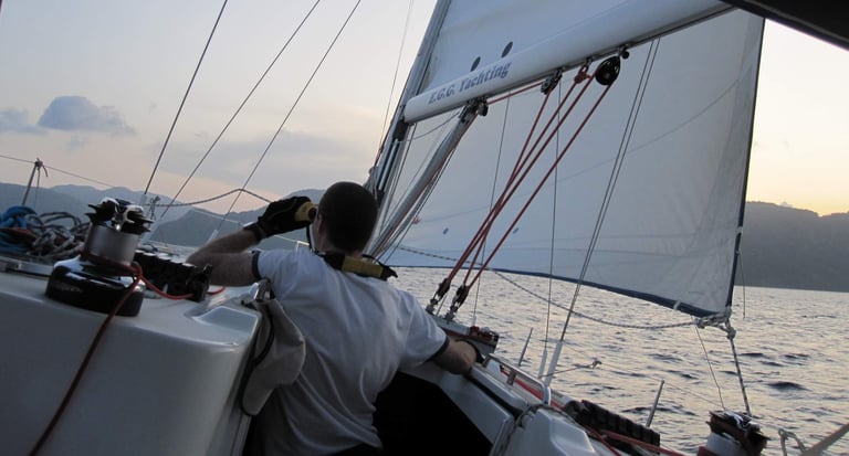a man in a white shirt is sitting on a boat. Copyright Vincent Volpe