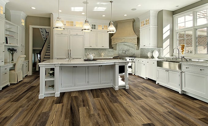 Comparing different flooring samples when choosing kitchen or bathroom flooring.
