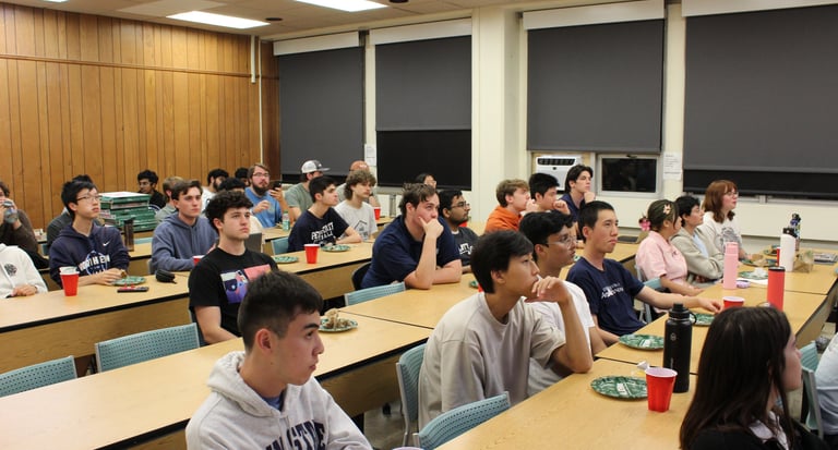 Penn State IEEE members at a meeting enjoying corporate sponsored food