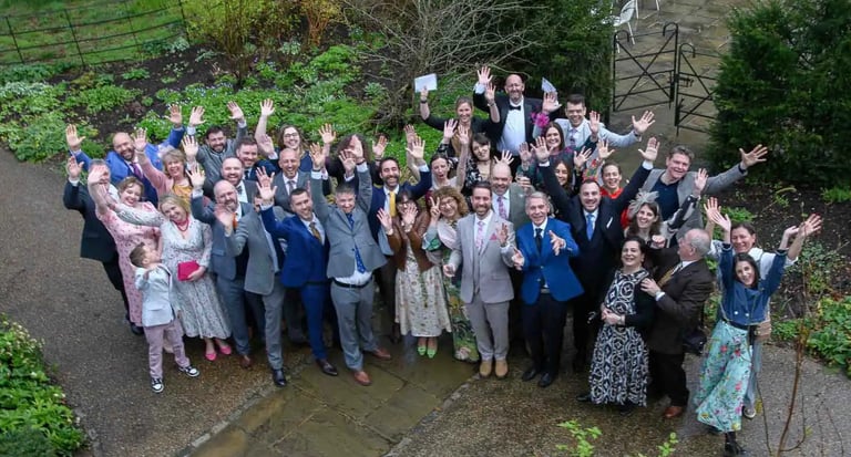 the entire wedding party in the grounds of Pembroke Lodge Richmond
