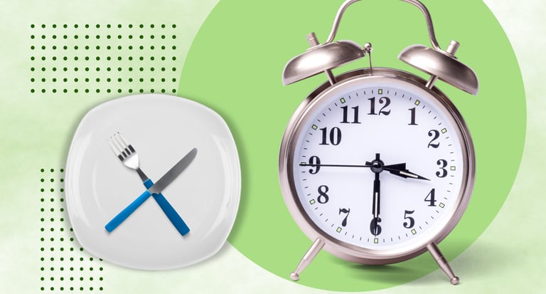 Intermittent fasting concept with an alarm clock and an empty plate with a fork and knife.