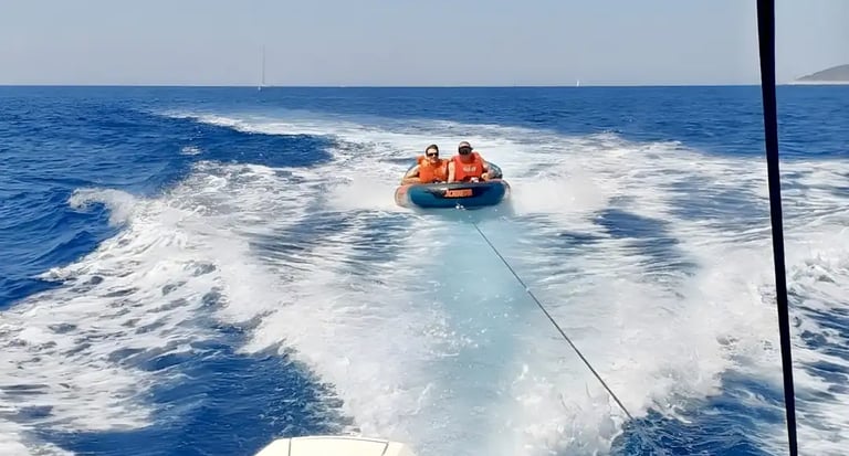 Guests enjoying JOBE towel tube as a part of Fun Pack on private boat tour from Split