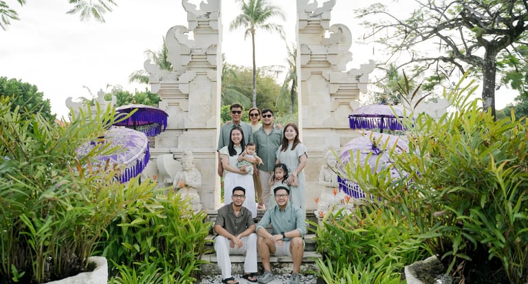Multigenerational family portrait at a traditional Balinese gate during a family photography session in Nusa Dua Bali.