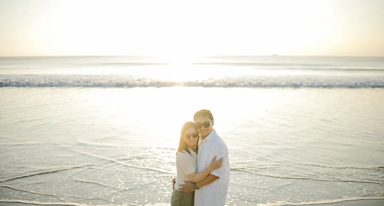 Family embracing during a sunset photography session at InterContinental Bali Resort beach