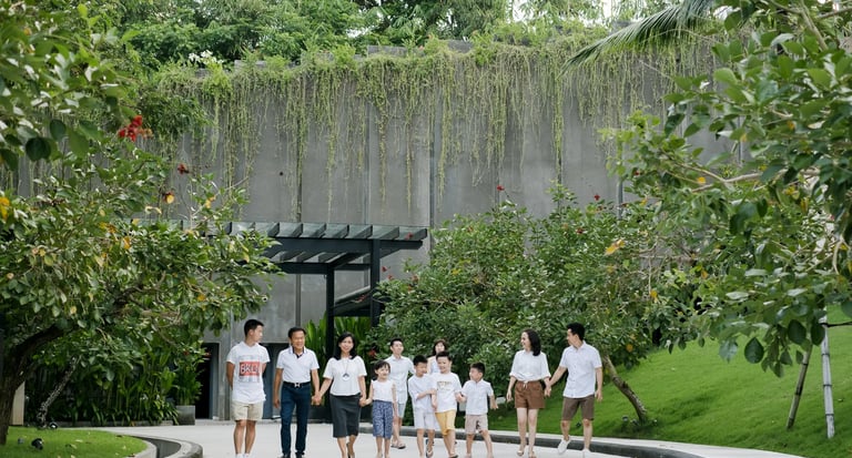 Multi-generation family walking through the tropical garden pathways at The Apurva Kempinski Bali