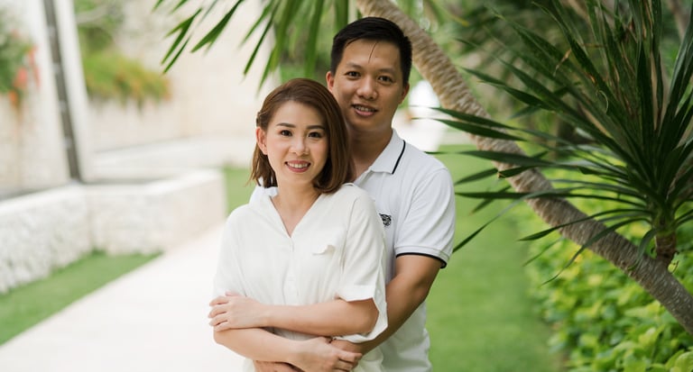 Couple portrait of Natalia's parents in tropical garden at The Mulia Nusa Dua Bali during a family photo session