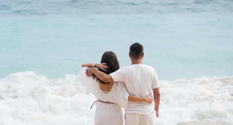 Couple from behind looking at the ocean at Karma Kandara Bali beach  