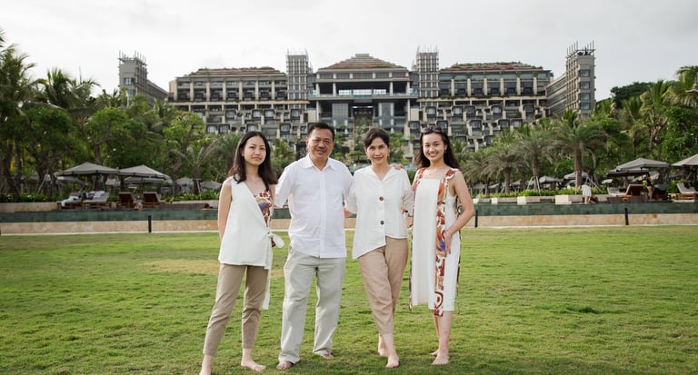Family portrait in the garden area during a family photography session at Kempinski Bali resort