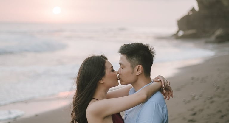 Intimate couple embrace during sunset photography session at Pantai Nyanyi Bali.