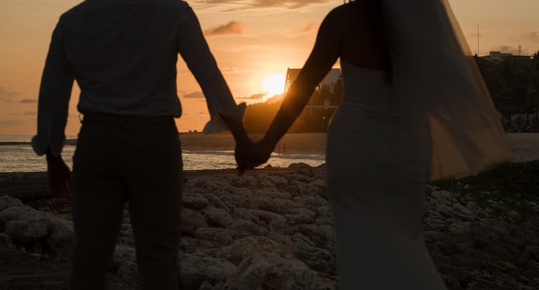 Silhouette of a couple holding hands during sunset prewedding photoshoot at Apurva Kempinski Bali beach