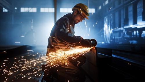 a man in a hard hat and a welding torch