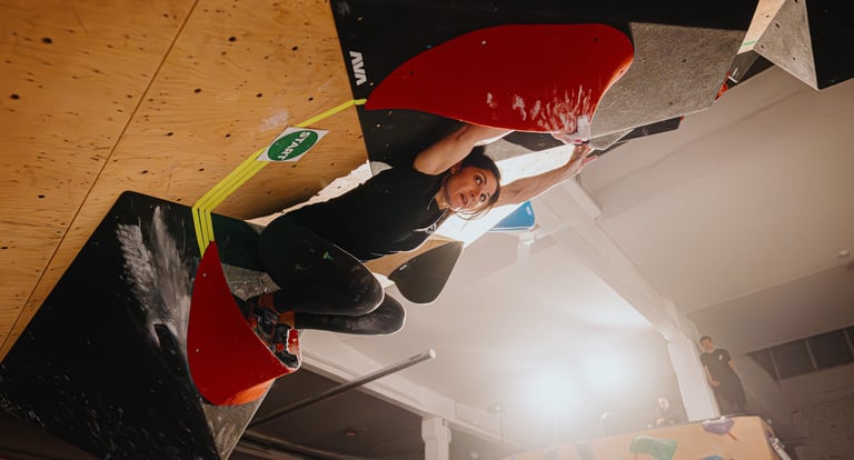 woman climbing in a bouldering competition