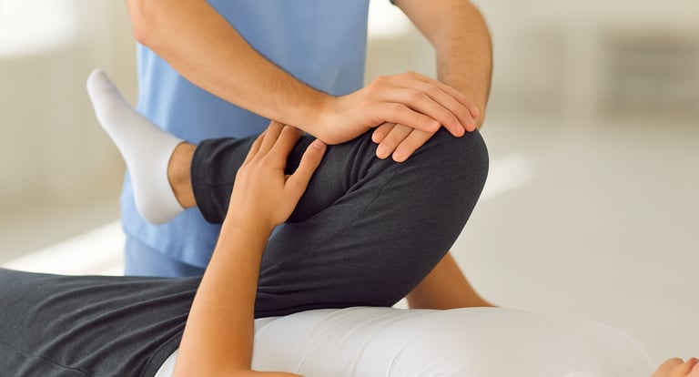 Physiotherapist applying manual therapy to relieve hip joint stiffness.