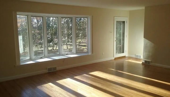 A finished interior painting job room with a window and a large window