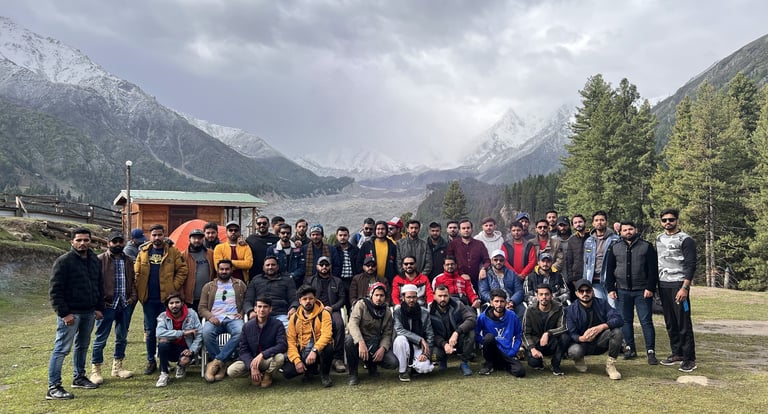 a group of people standing in front of a mountain