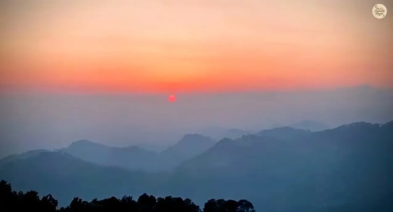 Sunset view from Naddi View Point, McLeod Ganj with clouds and Dhauladhar mountains.