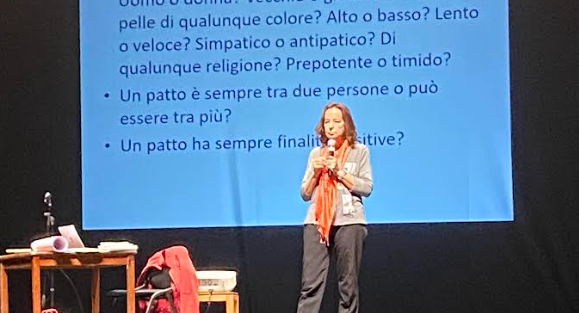 a woman standing on a stage with a microphone and a microphone