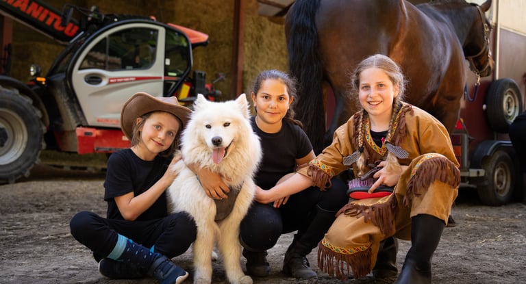 a boy in a cowboy hat and a dog are posing for a picture