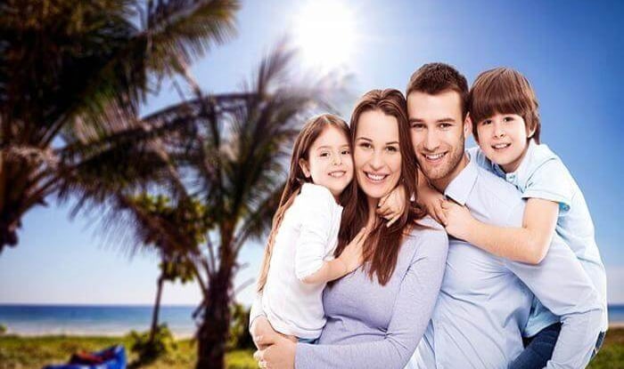 Smiling family standing together outdoors, expressing love and togetherness.