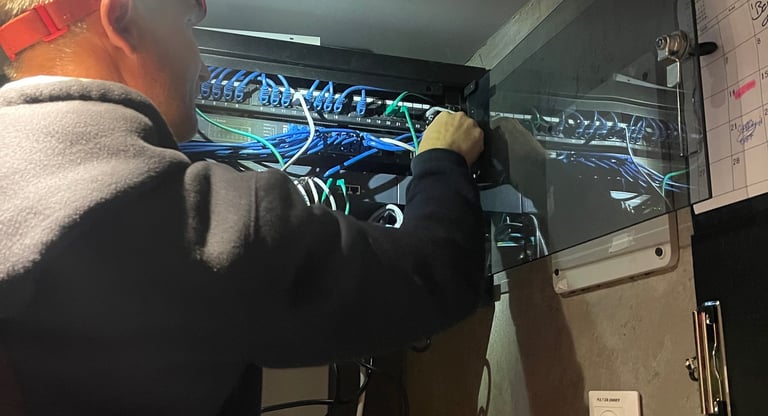 a man in a suit and glasses working on a computer
