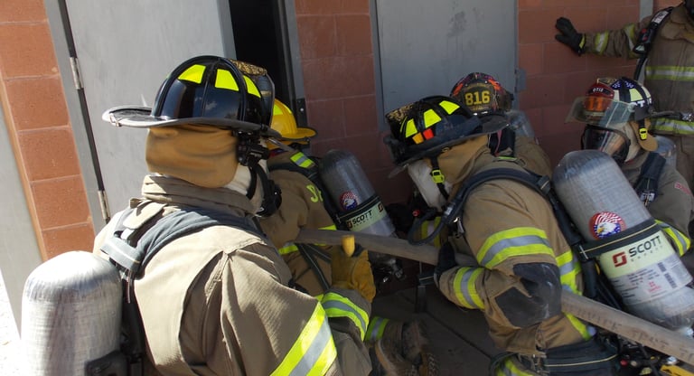 a group of firefighters in full gear training