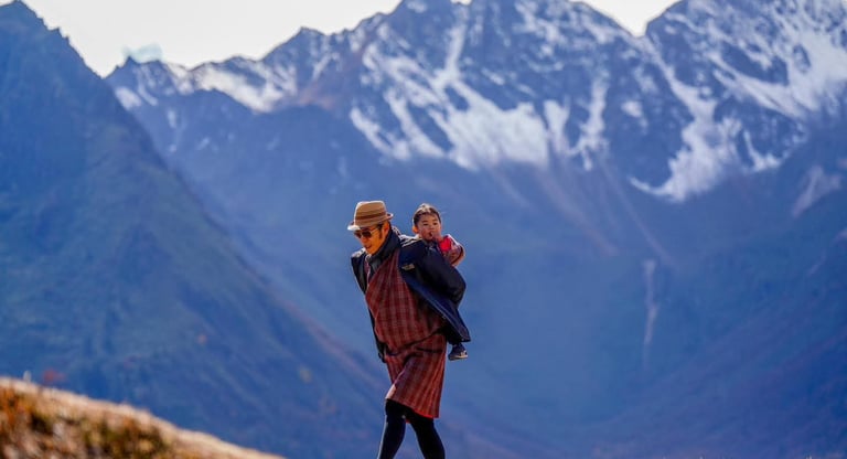 His-majesty-the-king-of-bhutan-with-princess-on-his-back-at-the-royal-highland-festival