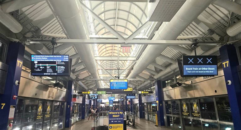 AirTrain terminal at JFK with route display showing train lines and destinations