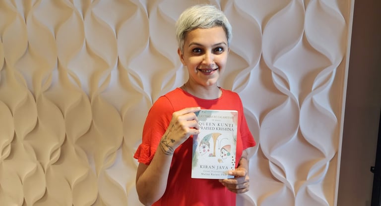 Dr. Malini Karani holds the newly designed cover for Let there be calamities by Kiran Java
