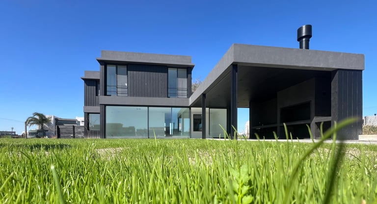 a house with a large grassy lawn and a car parked in front of it