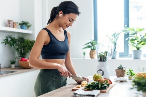 an athletic young lady making breakfast