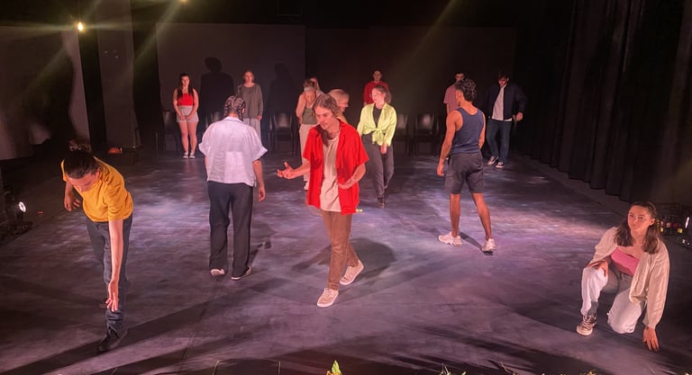 a group of people standing around a circle of flowers