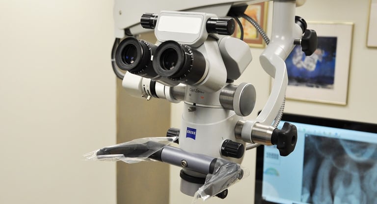 Professional Zeiss dental microscope used for precision endodontic procedures in a modern clinic.