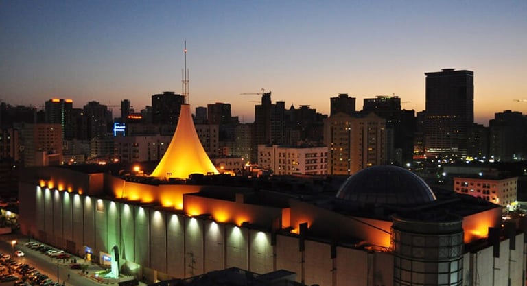 a city skyline at night time with a church and a church steeple