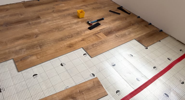 Plank flooring layed over waterproofing underlayment pad.