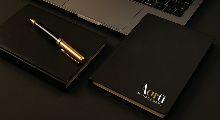 Aaru notebook and pen beside laptop