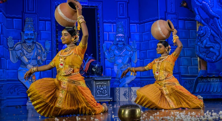 two women in traditional indian attire performing a dance