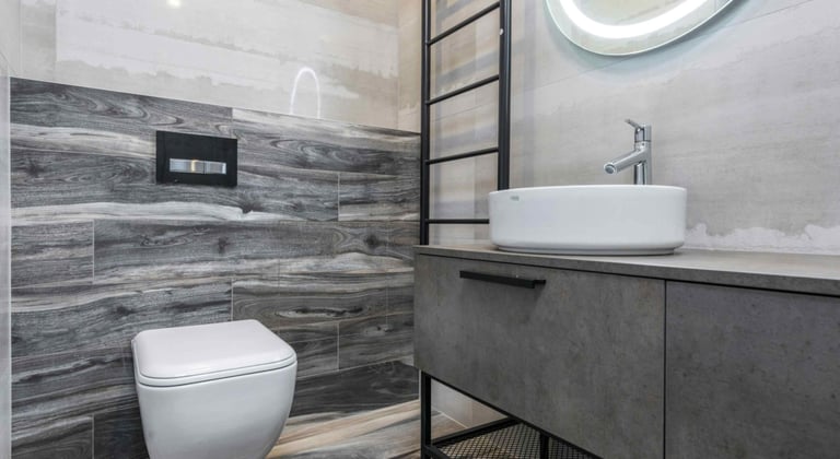 Modern grey-tiled bathroom with floating vanity