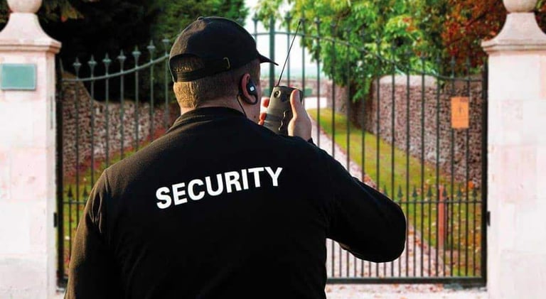 Security officer managing gated commercial property using two-way radio